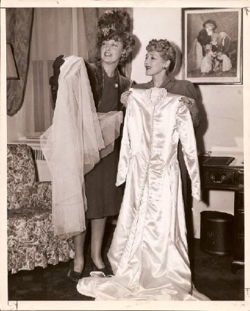 Mary Pickford and Jeannette MacDonald donating Pickford's gown